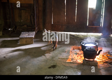 Cooking by wood fire inside house of minority group Black Hmong`s family, Sa Pa, Vietnam Stock Photo